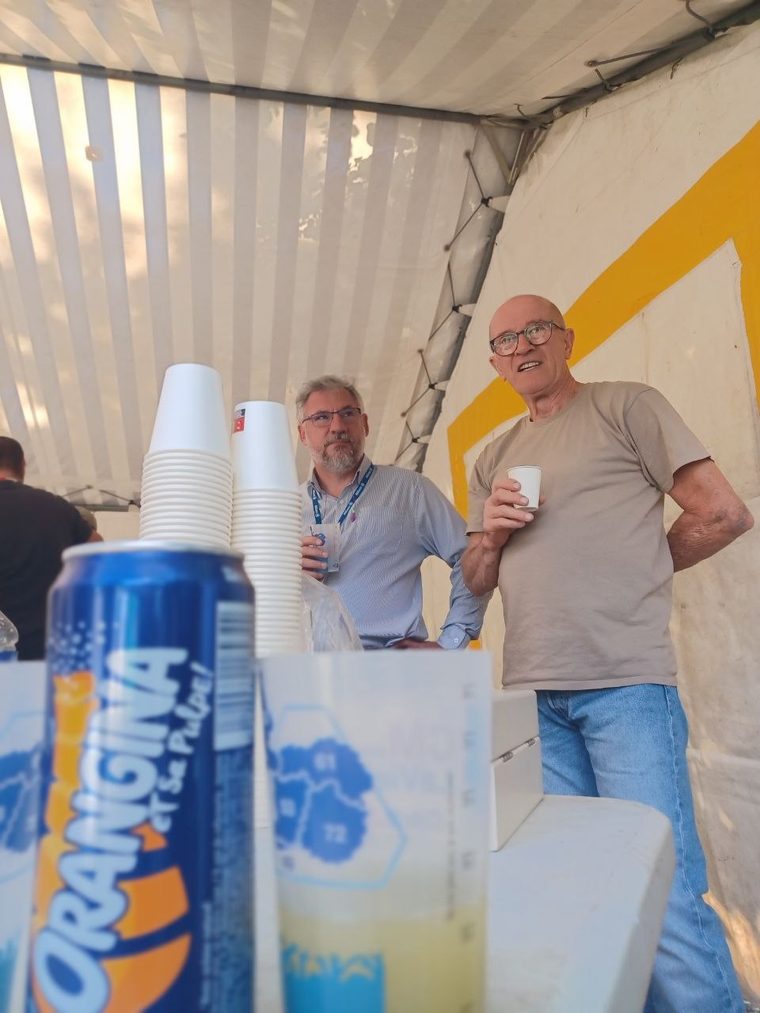 Deux bénévoles du club tiennent la buvette sous le barnum